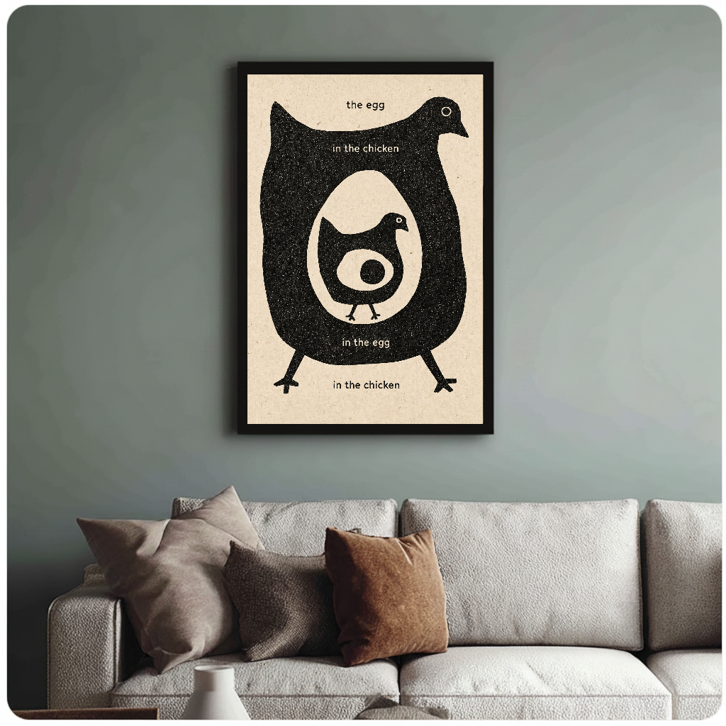 Framed artwork of a chicken and egg question above a sofa with muted cushions.