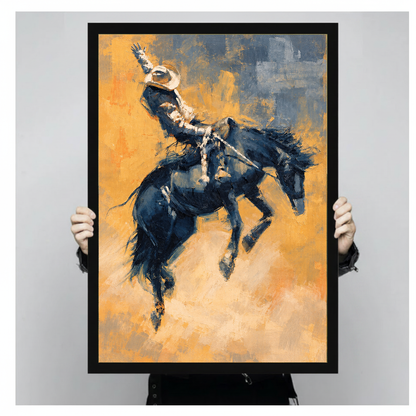 Framed artwork of a cowboy riding a bucking horse held by a person against a pale backdrop.