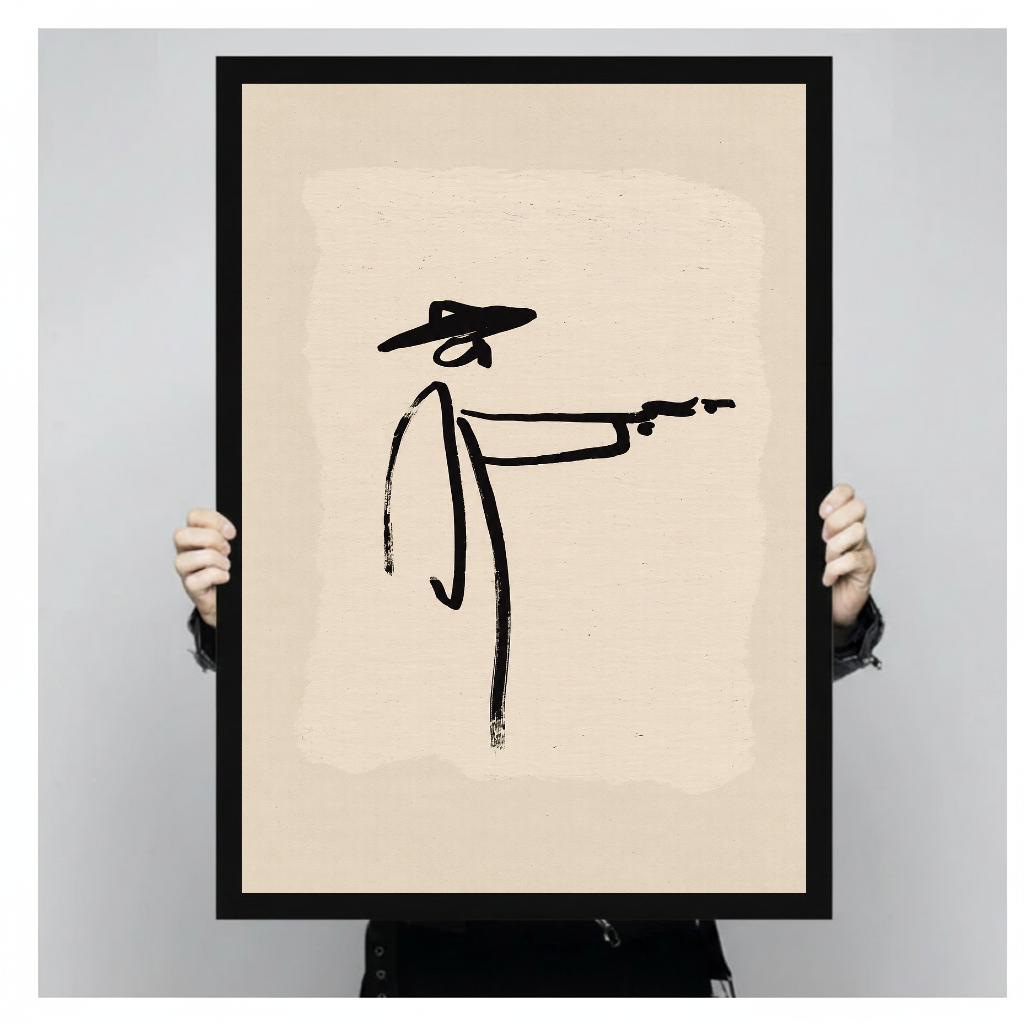 Person holding black framed minimalist brushstroke cowboy artwork against a plain pale background.