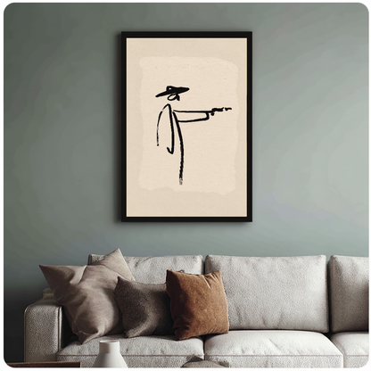 Framed minimalist brushstroke cowboy painting above a sofa with muted cushions against a green-gray wall.