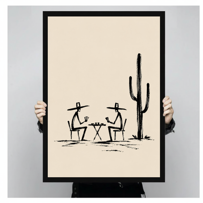 A person holds black framed cowboys playing cards canvas against a light neutral background.