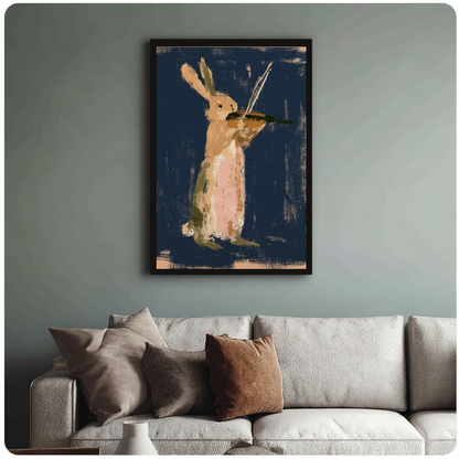 Framed rabbit playing violin canvas above a neutral sofa with cushions against a muted wall.