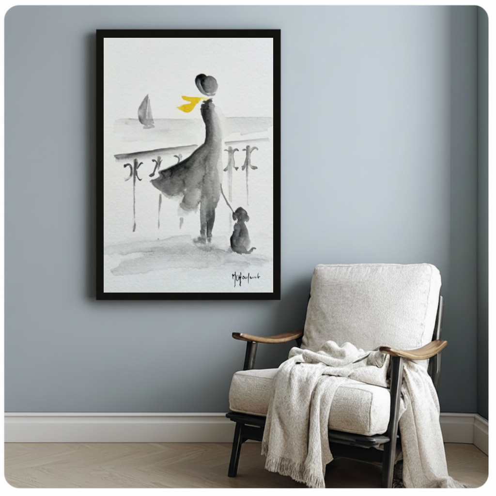 Framed yellow scarf seaside companions canvas beside a pale reading chair on a blue gray wall.