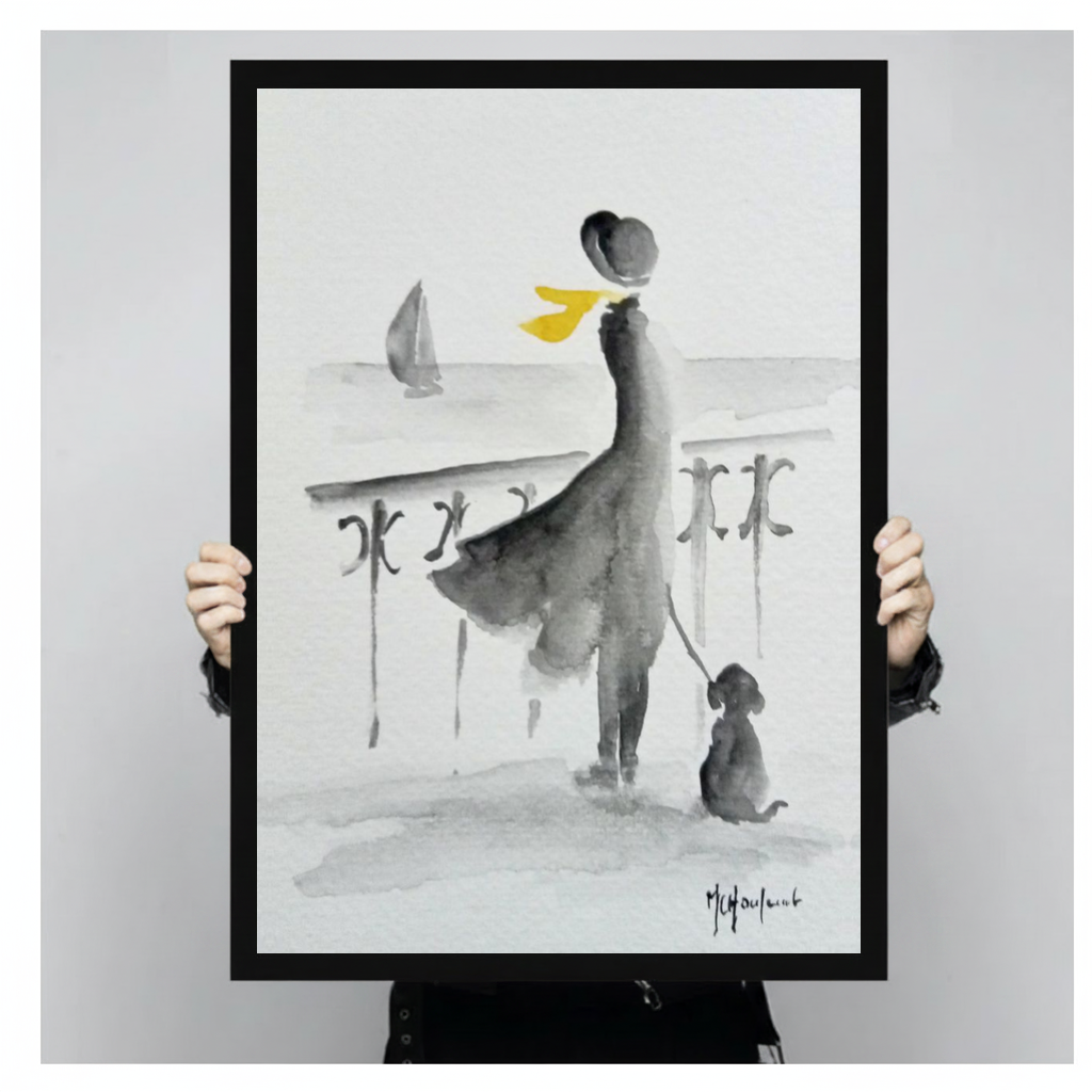 A person holds black framed yellow scarf seaside companions canvas against a light neutral background.