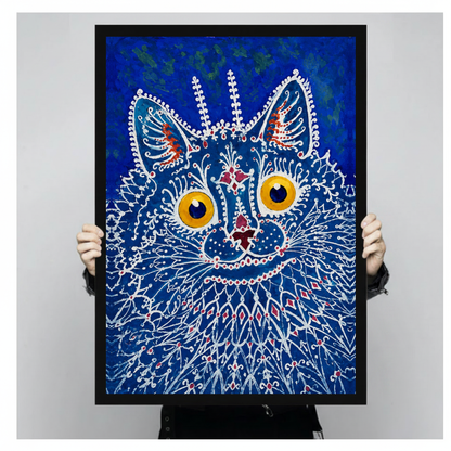 A person holds black framed blue lacework cat canvas against a light neutral background.