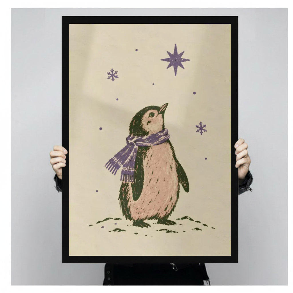 A person holds black framed penguin under purple stars canvas against a light neutral background.