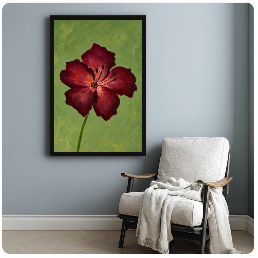 Framed burgundy bloom on olive canvas beside a pale reading chair on a blue gray wall.