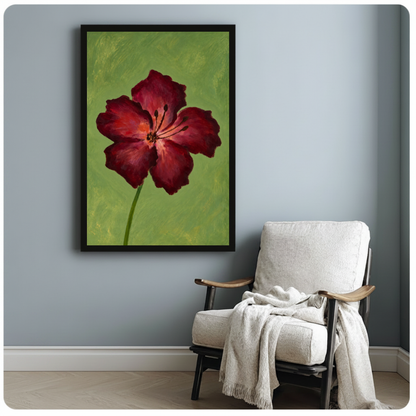 Framed burgundy bloom on olive canvas beside a pale reading chair on a blue gray wall.