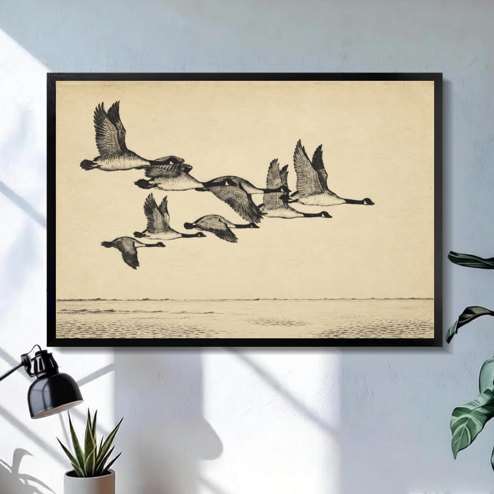 Black framed flying geese over quiet water canvas above a console in the selected room setting.