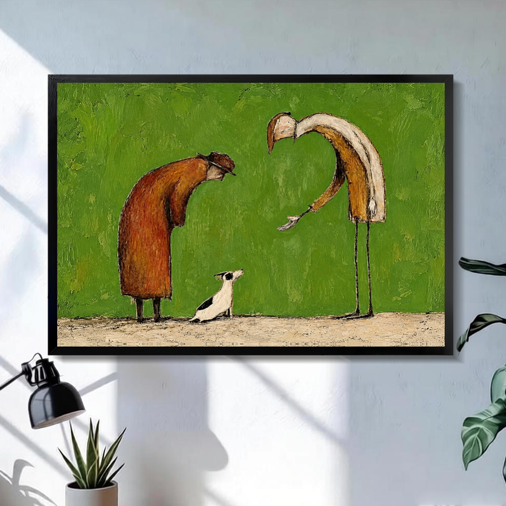 Black framed kind strangers small dog canvas on a pale wall above a desk and plant.