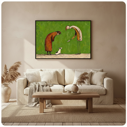 Framed kind strangers small dog canvas above a neutral sofa beside pampas grass and a coffee table.
