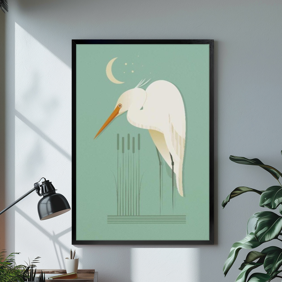Black framed moonlit white egret canvas on a pale wall above a desk and plant.
