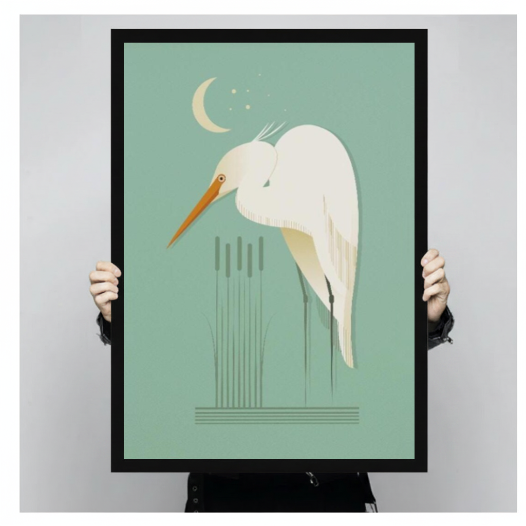 Framed moonlit white egret canvas held by a person against a light neutral background.