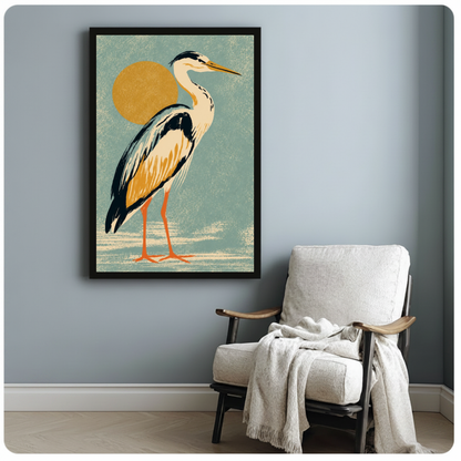 Framed golden sun heron canvas beside a pale reading chair on a blue gray wall.
