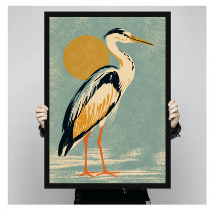 Framed golden sun heron canvas held by a person against a light neutral background.