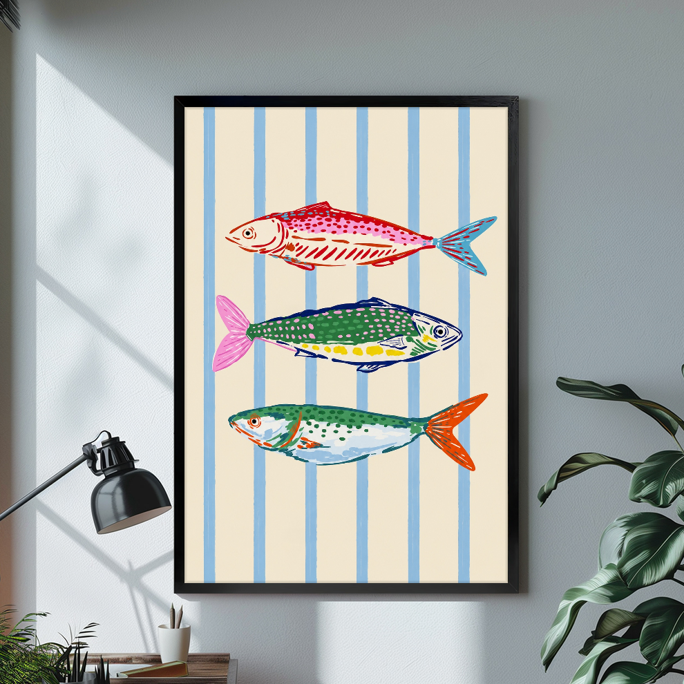 Black framed colorful fish blue stripes canvas on a pale wall above a desk and plant.