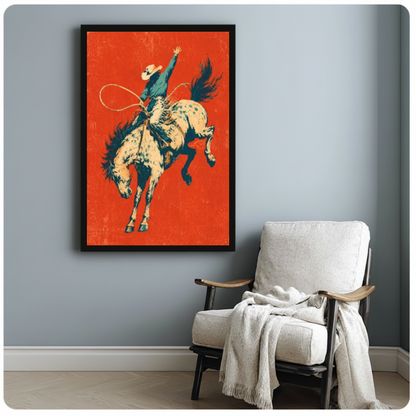 Framed bucking bronco rodeo rider canvas beside a pale reading chair on a blue gray wall.