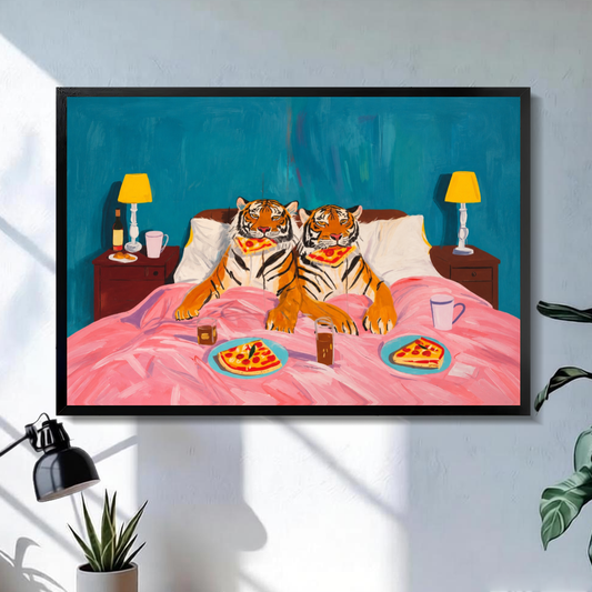 Black framed tigers enjoy pizza in bed canvas on a pale wall above a desk and plant.