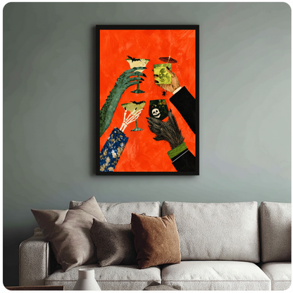 Framed monster hands cocktail toast canvas above a neutral sofa with cushions against a muted wall.