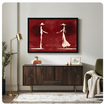 Framed ghostly western dance pair canvas above a wooden sideboard beside books and an angled brass lamp.