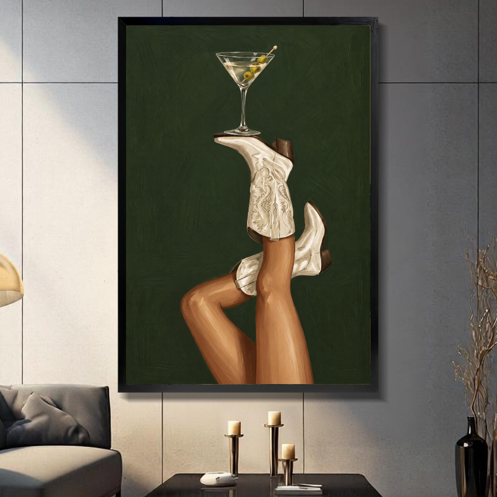 Black framed cowgirl boots martini balance canvas on a dark paneled wall beside warm candles.