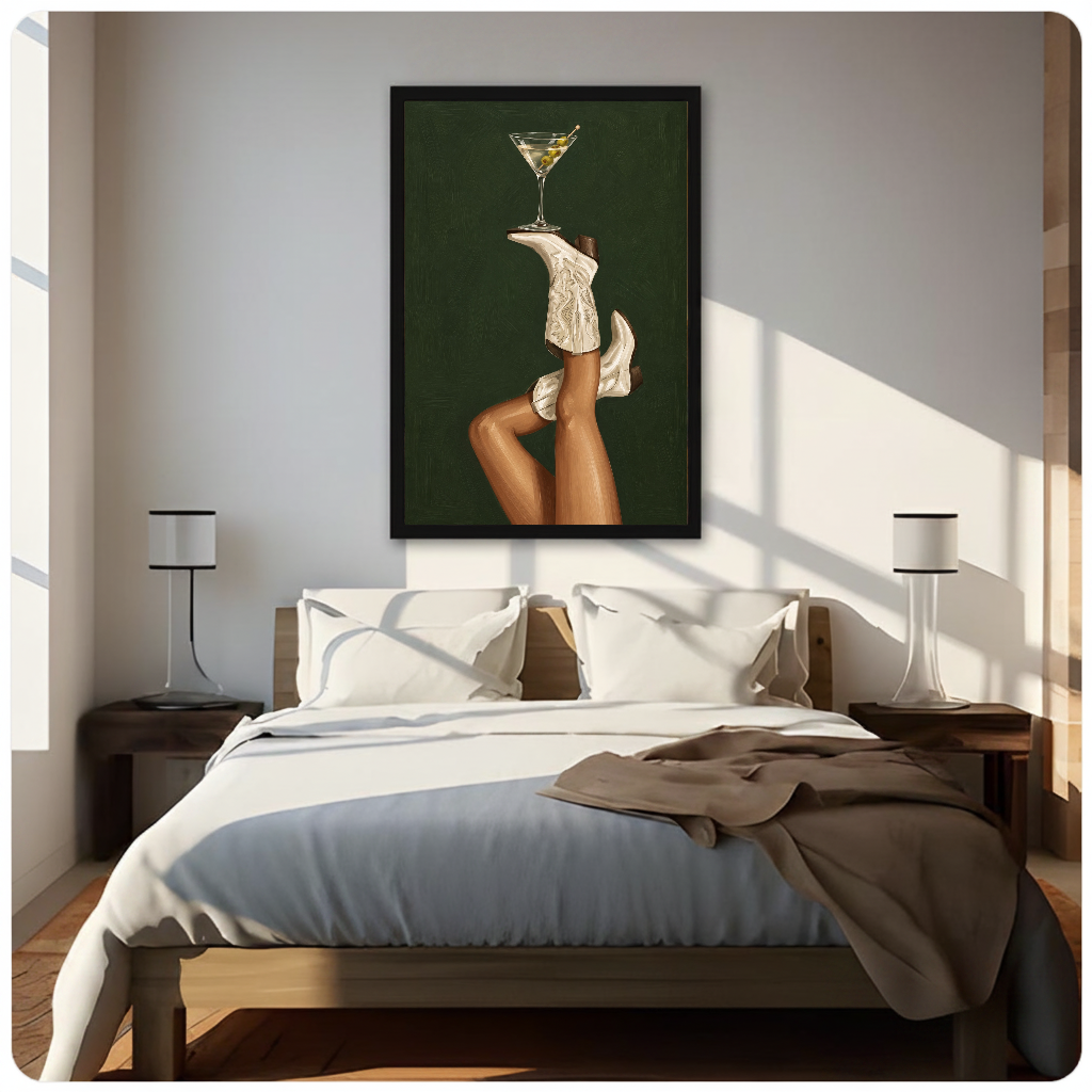 Framed cowgirl boots martini balance canvas above a neutral bed beside soft bedroom lighting and lamps.