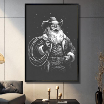 Black framed cowboy santa with lasso canvas on a dark paneled wall beside warm candles.