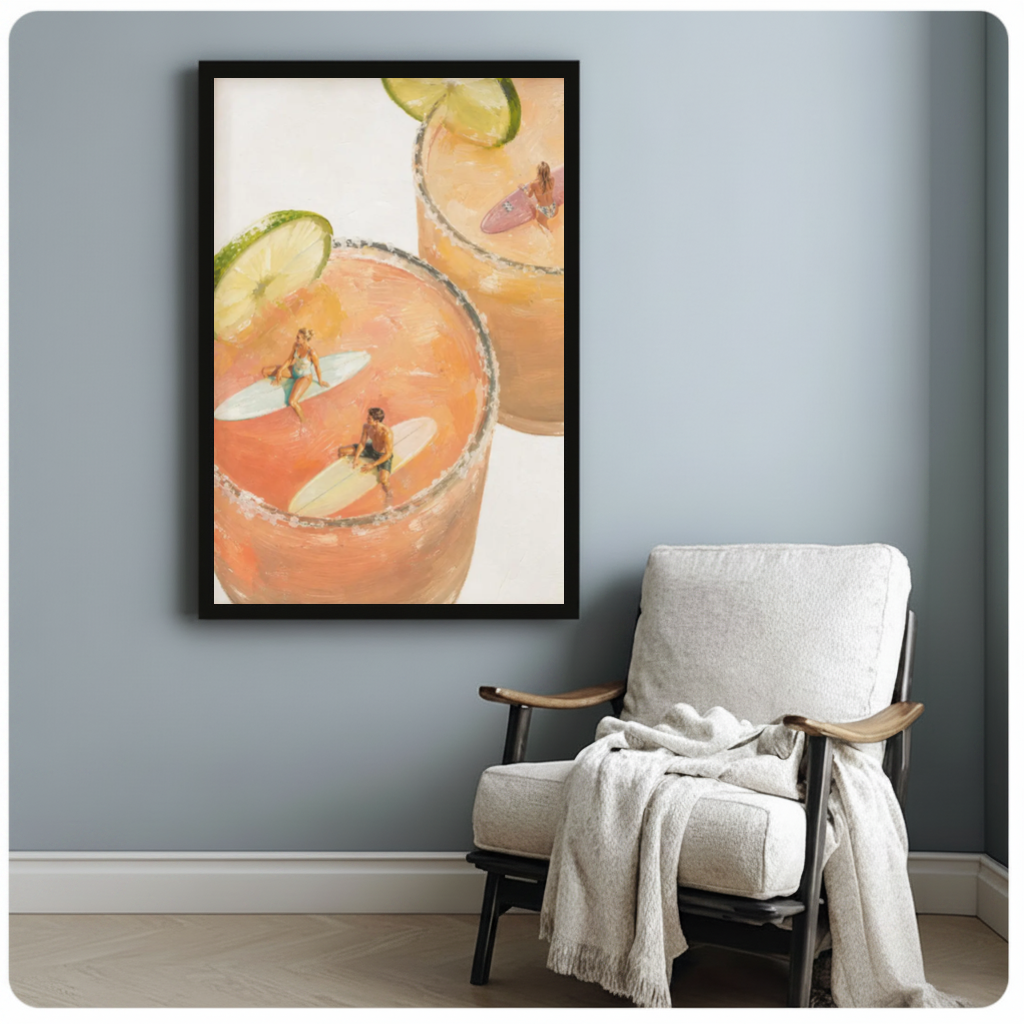 Framed tiny surfers cocktail pools canvas beside a pale reading chair on a blue gray wall.