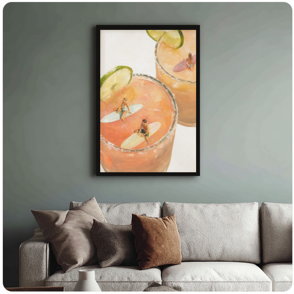 Framed tiny surfers cocktail pools canvas above a neutral sofa with cushions against a muted wall.