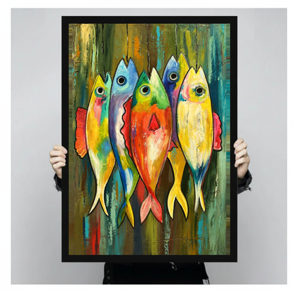 Framed five colorful hanging fish canvas held by a person against a light neutral background.