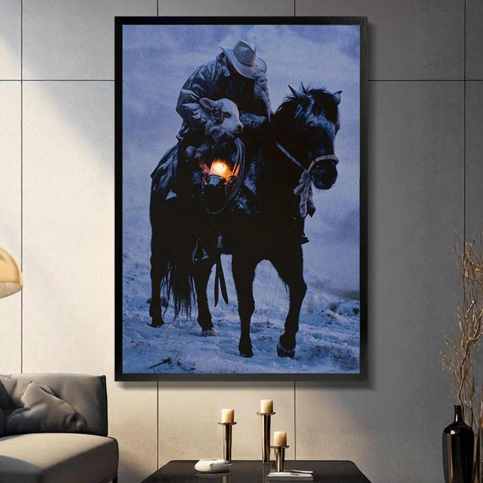 Black framed cowboy carrying lamb canvas on a dark paneled wall beside warm candles.