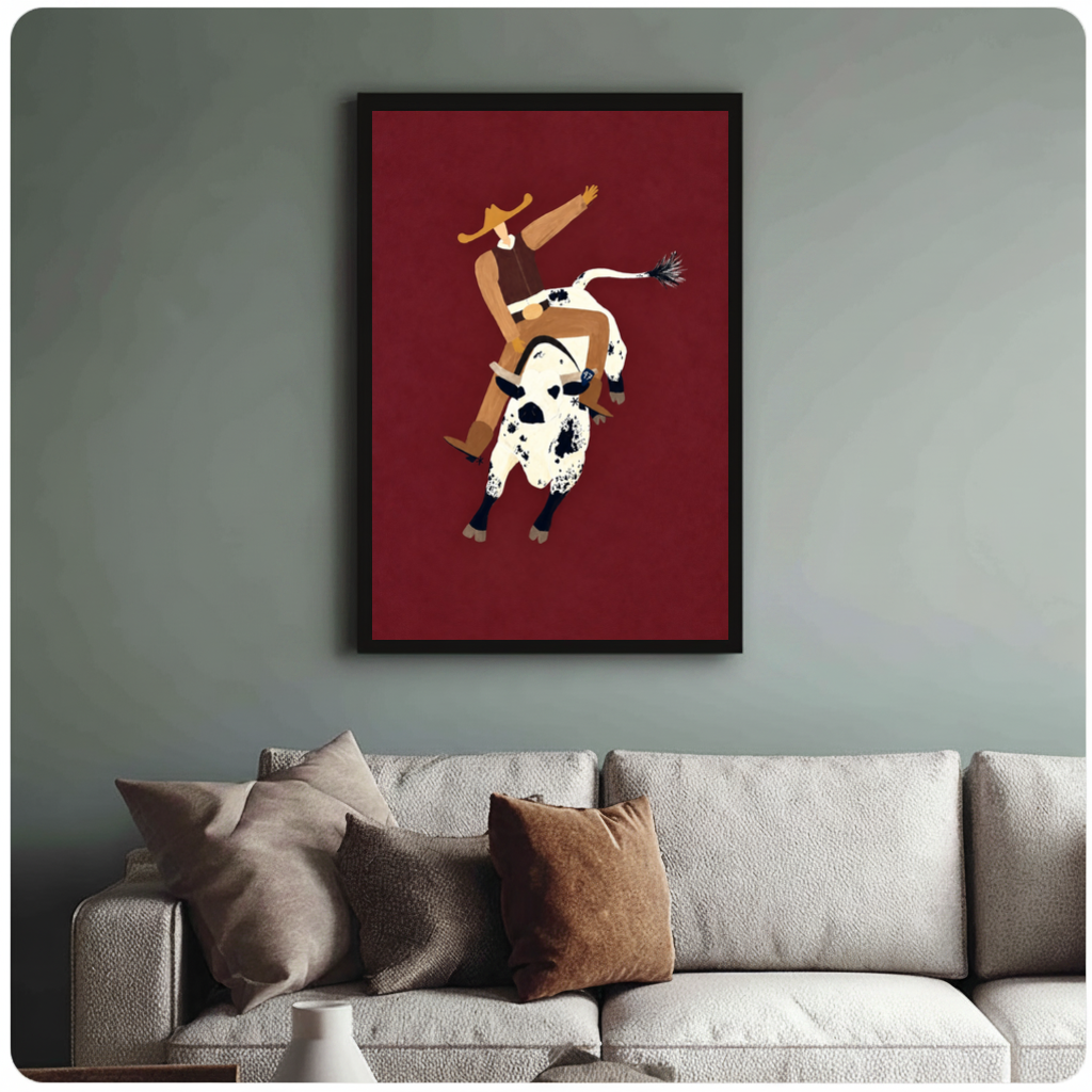 Framed burgundy rodeo rider canvas above a neutral sofa with cushions against a muted wall.