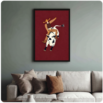 Framed burgundy rodeo rider canvas above a neutral sofa with cushions against a muted wall.