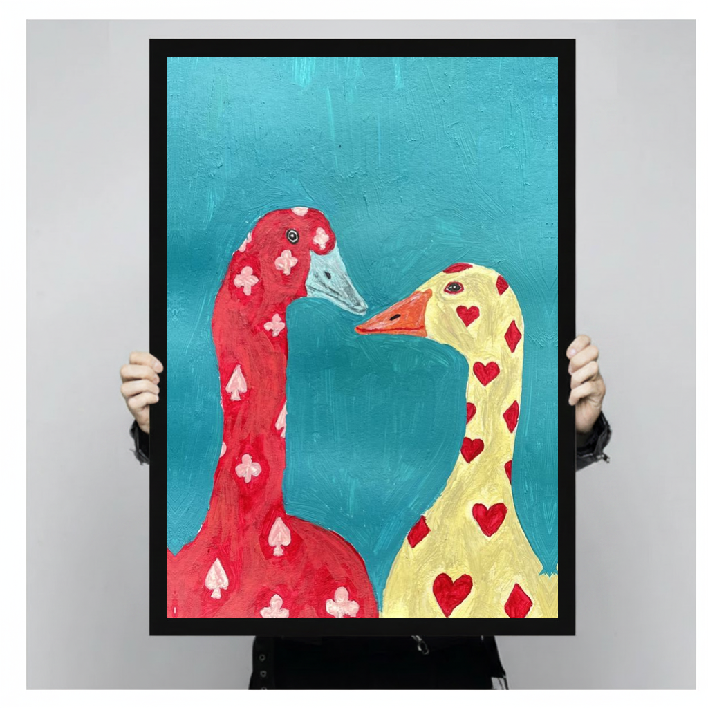 Framed playing card geese canvas held by a person against a light neutral background.