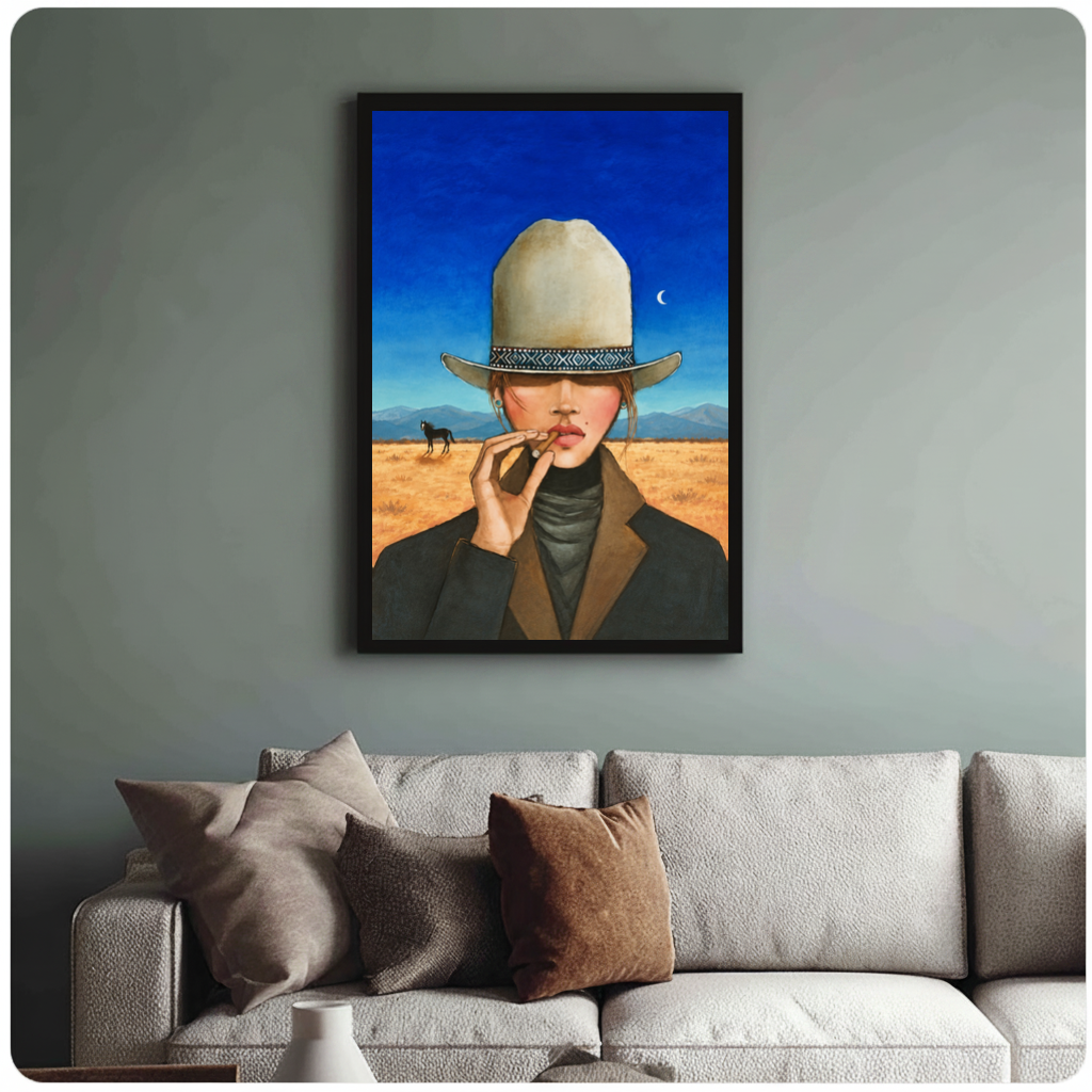 Framed blue sky cigar cowgirl canvas above a neutral sofa with cushions against a muted wall.