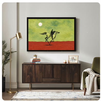 Framed moonlit ink cowboy horse canvas above a wooden sideboard beside books and an angled brass lamp.