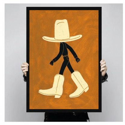 Framed walking hat and boots canvas held by a person against a light neutral background.