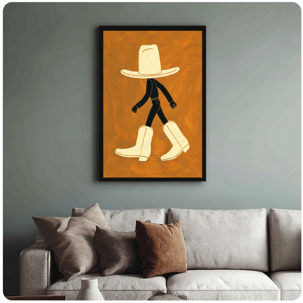Framed walking hat and boots canvas above a neutral sofa with cushions against a muted wall.