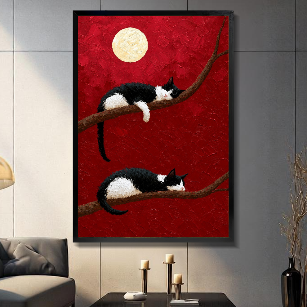 Black framed sleeping cats full moon canvas on a dark paneled wall beside warm candles.