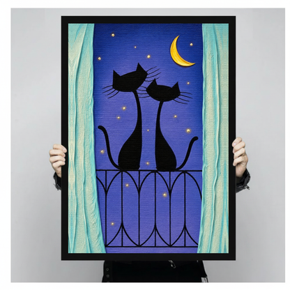 Framed balcony cats purple night canvas held by a person against a light neutral background.
