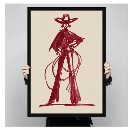 Framed burgundy lasso cowboy canvas held by a person against a light neutral background.