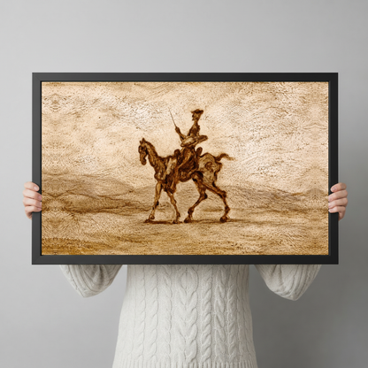 Framed sepia western horse rider canvas held horizontally by a person wearing a cream sweater against a light background.