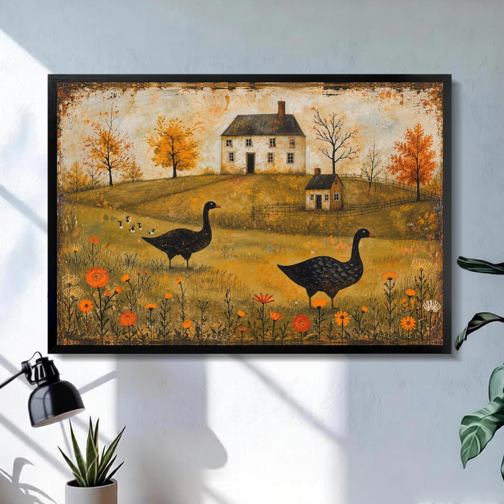 Black framed autumn geese farmhouse canvas on a pale wall above a desk and plant.