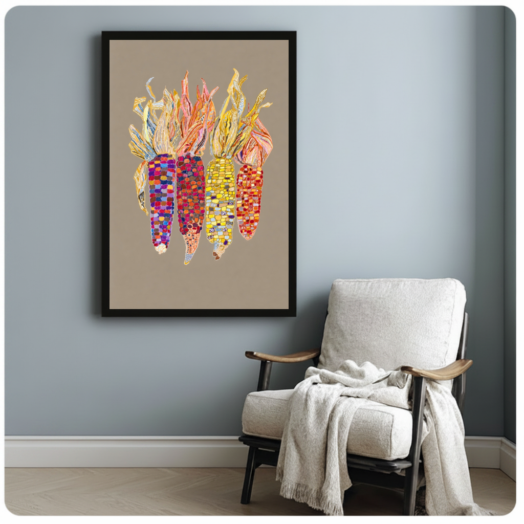 Framed colorful beaded corn canvas beside a pale reading chair on a blue gray wall.