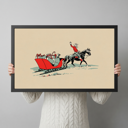 Framed christmas cowboy gift sleigh canvas held horizontally by a person wearing a cream sweater against a light background.