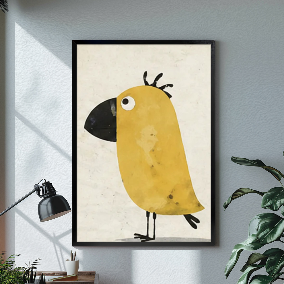 Black framed funny yellow bird canvas on a pale wall above a desk and plant.