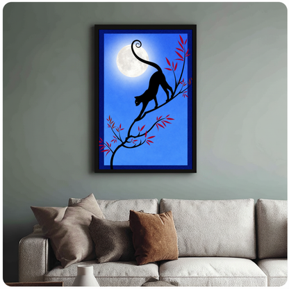 Framed moonlit branch black cat canvas above a neutral sofa with cushions against a muted wall.