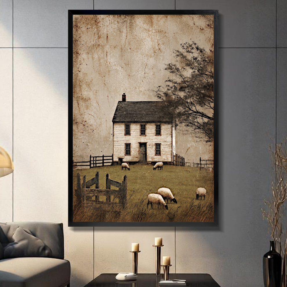 Black framed old farmhouse grazing sheep canvas on a dark paneled wall beside warm candles.