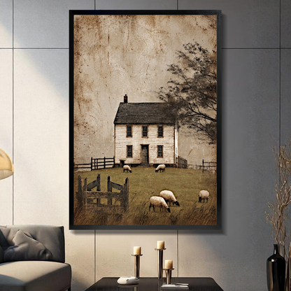 Black framed old farmhouse grazing sheep canvas on a dark paneled wall beside warm candles.