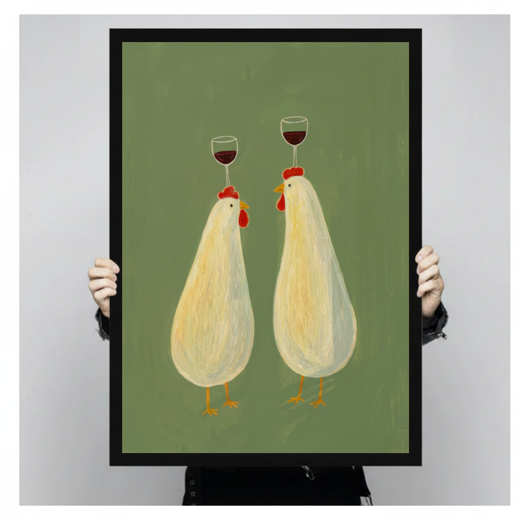 Framed wine balancing chickens canvas held by a person against a light neutral background.